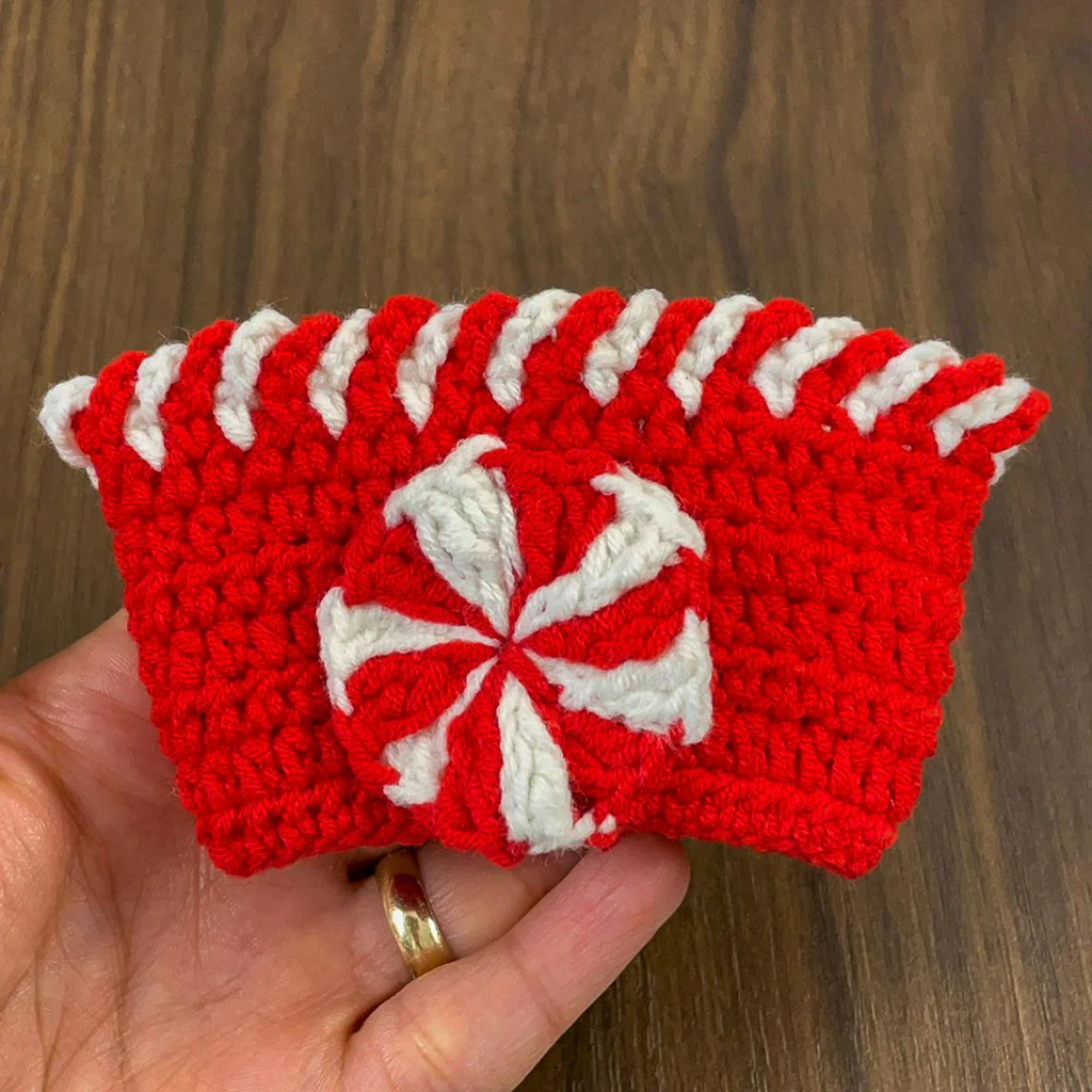 Crochet peppermint cup cozy in red and white – festive handmade Christmas design